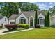 Charming home featuring a brick facade, manicured lawn, and lush landscaping at 2545 Tilson Se Dr, Atlanta, GA 30317