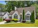 Charming home featuring a brick facade, manicured lawn, and lush landscaping at 2545 Tilson Se Dr, Atlanta, GA 30317
