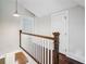 Second story hallway featuring hardwood floors and neutral paint and trim at 2545 Tilson Se Dr, Atlanta, GA 30317