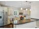 Modern kitchen with stainless steel appliances, granite countertops, and stylish pendant lighting at 2545 Tilson Se Dr, Atlanta, GA 30317