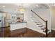 Bright open-concept kitchen featuring stainless steel appliances and adjacent staircase to the second floor at 2545 Tilson Se Dr, Atlanta, GA 30317