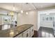 Modern kitchen featuring granite countertops, stylish cabinets, and open layout to a living space at 2545 Tilson Se Dr, Atlanta, GA 30317