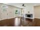 Living room with hardwood floors, fireplace, bay window, and a ceiling fan at 2545 Tilson Se Dr, Atlanta, GA 30317