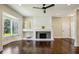 Bright living room featuring hardwood floors, a fireplace, ceiling fan, and large windows at 2545 Tilson Se Dr, Atlanta, GA 30317