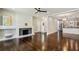 Open concept living room showcasing hardwood floors, fireplace, and seamless transition to the kitchen at 2545 Tilson Se Dr, Atlanta, GA 30317