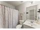 Bathroom featuring a vanity and toilet, complemented by neutral tones and a patterned shower curtain at 3427 Hampreston Nw Way, Kennesaw, GA 30144