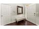 Welcoming entryway featuring hardwood floors, a tufted bench, decorative mirror, and bright natural light at 3427 Hampreston Nw Way, Kennesaw, GA 30144