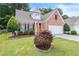 Charming single-Gathering home with lush green lawn, colorful landscaping, and a classic brick facade at 3427 Hampreston Nw Way, Kennesaw, GA 30144