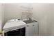 Laundry room with modern washer and dryer units and wire shelving for storage at 3427 Hampreston Nw Way, Kennesaw, GA 30144
