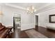 Bright living space featuring wood floors, white wainscotting, elegant lighting, and neutral walls at 3427 Hampreston Nw Way, Kennesaw, GA 30144