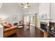 Bright living room with hardwood floors, fireplace, vaulted ceilings, and sliding glass doors to porch at 3427 Hampreston Nw Way, Kennesaw, GA 30144