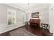 Elegant living area with hardwood floors, shutters, wainscotting, and sophisticated decor at 3427 Hampreston Nw Way, Kennesaw, GA 30144