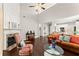 Living room featuring fireplace, hardwood floors and mantel, with connection to the kitchen at 3427 Hampreston Nw Way, Kennesaw, GA 30144