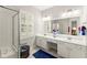 Bathroom featuring double sink vanity with cabinets, large mirror, shower, and neutral tones at 3427 Hampreston Nw Way, Kennesaw, GA 30144