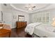 Bright main bedroom with hardwood floors, shuttered windows, tray ceiling, and neutral tones at 3427 Hampreston Nw Way, Kennesaw, GA 30144