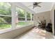 Bright sunroom with ceiling fan offering views of the lush backyard and access to the outdoors at 3427 Hampreston Nw Way, Kennesaw, GA 30144