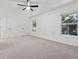 Bright and spacious bedroom with ceiling fan, neutral carpet and trim, and large windows at 2130 Executive Dr, Duluth, GA 30096