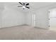 Expansive bedroom with neutral paint, ceiling fan, wall trim, and an adjoining bathroom at 2130 Executive Dr, Duluth, GA 30096