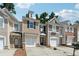 Attractive townhomes featuring neutral exteriors, single-car garages, and well-maintained landscaping at 2130 Executive Dr, Duluth, GA 30096