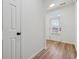 Bright hallway boasting hardwood floors and a white door leading to the backyard at 2130 Executive Dr, Duluth, GA 30096