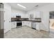 Updated kitchen featuring stainless steel appliances, white cabinets, and tile backsplash at 2130 Executive Dr, Duluth, GA 30096