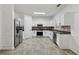 Spacious kitchen with stainless steel refrigerator and appliances, and tile flooring at 2130 Executive Dr, Duluth, GA 30096