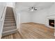 Bright, spacious living room featuring hardwood floors, fireplace, and staircase access at 2130 Executive Dr, Duluth, GA 30096