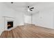 Spacious living room with hardwood floors, fireplace, and a modern ceiling fan creating inviting atmosphere at 2130 Executive Dr, Duluth, GA 30096