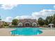 Community center with swimming pool surrounded by lush landscaping on a sunny day at 2130 Executive Dr, Duluth, GA 30096
