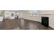 The open-concept living space features wood floors, a fireplace and a modern kitchen at 271 Sandy Oak Dr, Loganville, GA 30052