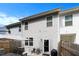 View of the backyard, showcasing the home's exterior, patio seating, and a privacy fence at 5696 Union Pointe Dr, Union City, GA 30291