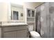 Well-maintained bathroom featuring a toilet, shower curtain and vanity with storage at 5696 Union Pointe Dr, Union City, GA 30291