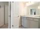 Clean bathroom featuring neutral gray cabinets, a large mirror, and a tiled floor at 5696 Union Pointe Dr, Union City, GA 30291