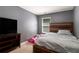 Bedroom with a rustic wooden headboard, a television, and a cozy bed at 5696 Union Pointe Dr, Union City, GA 30291