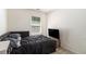 Bedroom featuring a large window, a bed with gray bedding, a television, and light beige carpet at 5696 Union Pointe Dr, Union City, GA 30291