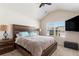 Inviting bedroom features a large window, ceiling fan, and comfortable bed with a wooden headboard at 5696 Union Pointe Dr, Union City, GA 30291