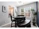 Cozy dining area featuring a wooden table, bench seating, and natural light from the window at 5696 Union Pointe Dr, Union City, GA 30291