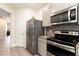 Bright kitchen featuring stainless steel appliances, including a refrigerator, stove, and microwave at 5696 Union Pointe Dr, Union City, GA 30291