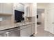 Well-lit kitchen features modern stainless steel appliances, stone countertops and gray cabinetry at 5696 Union Pointe Dr, Union City, GA 30291