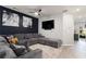 Comfortable living room featuring a large sectional, accent wall, and mounted TV at 5696 Union Pointe Dr, Union City, GA 30291
