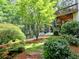 Idyllic backyard with mature trees, covered patio, and outdoor seating area at 658 Vinings Estates Se Dr, Mableton, GA 30126