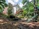 Spacious backyard with lush landscaping and a playset, perfect for outdoor activities at 658 Vinings Estates Se Dr, Mableton, GA 30126