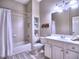 Bright bathroom featuring a shower-tub combination, a white vanity, and a large mirror with excellent lighting at 658 Vinings Estates Se Dr, Mableton, GA 30126
