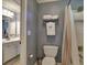 Cozy bathroom featuring a toilet, tiled shower, and towel rack for a comfortable and convenient experience at 658 Vinings Estates Se Dr, Mableton, GA 30126
