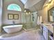Bright bathroom features modern tub, glass shower, and marble floors at 658 Vinings Estates Se Dr, Mableton, GA 30126