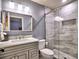 Modern bathroom with grey vanity, glass shower, and custom tile work at 658 Vinings Estates Se Dr, Mableton, GA 30126