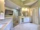 Bathroom with single vanity, mounted TV, and modern marble-style tile floors at 658 Vinings Estates Se Dr, Mableton, GA 30126