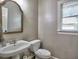 Cozy powder room featuring classic fixtures, a wood-trimmed mirror, and a window for natural light at 658 Vinings Estates Se Dr, Mableton, GA 30126