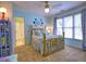 Charming bedroom featuring a brass bed, soft blue walls, and large windows, creating a serene and inviting space at 658 Vinings Estates Se Dr, Mableton, GA 30126