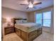 Comfortable bedroom with upholstered bed, bedside table, and natural light from window at 658 Vinings Estates Se Dr, Mableton, GA 30126